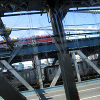 View out of train along Brooklyn Bridge